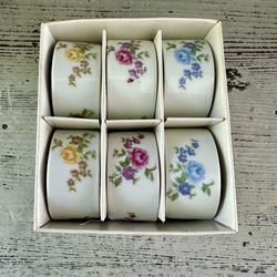 Set of 6 vintage porcelain ceramic floral rose napkin rings Japan  Unused in original box. Pink yellow and blue roses 2 of each color. 