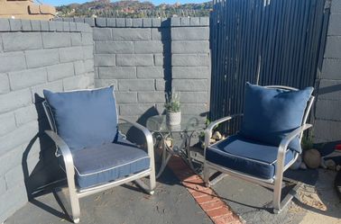 Patio wrought iron chairs including cushions .