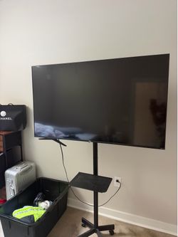 TCL Roku Smart TV (55”)+ Mobile TV Stand