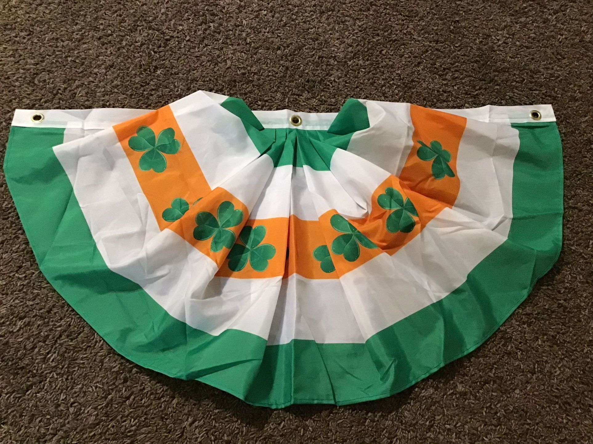 Green Foil Curtain And Two Clover Table Decorations