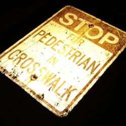 STOP FOR PEDESTRIAN IN CROSSWALK SIGN
