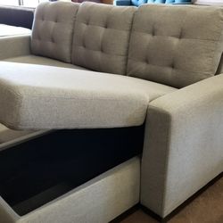 Light gray sofa chaise sectional with a pullout bed