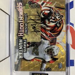 2024 Wild Card Football Dino Might Travis Hunter Saber Tooth Gold Autographed Numbered #1/1 Rookie Card PHST-THA This card is in Very Good Condition. 