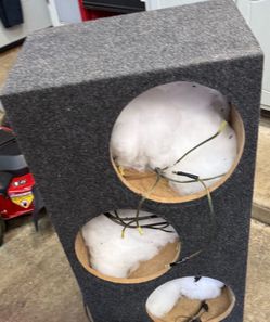 custom carpeted 3×12-inch subwoofer enclosure/box, with the speakers removed. The wiring and polyfill are still inside.