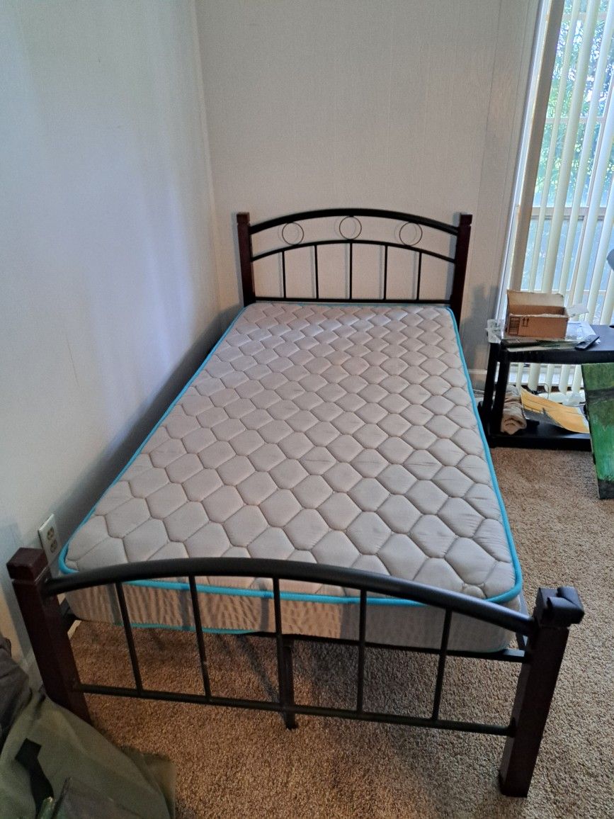 Solid Wood and Metal Twin bed in great condition with Matress sheets and foam pads.