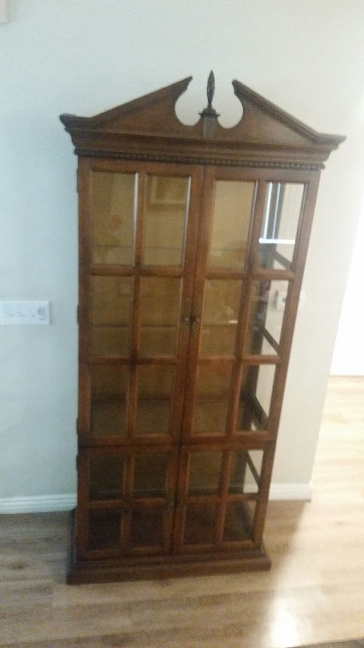 Tall antique curio cabinet with glass shelves