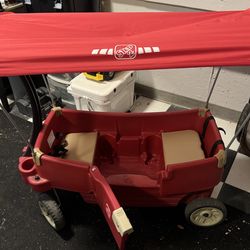 Red children’s wagon with canopy