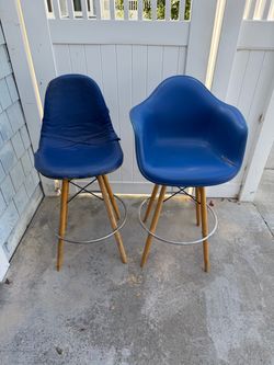 Two real MCM fiberglass Eames swivel bar chairs by Herman Miller from the 70s