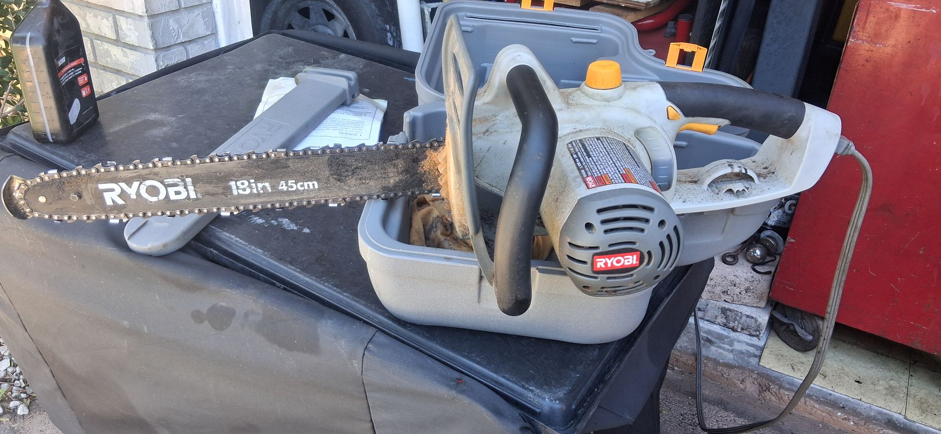 Ryobi RY43006 corded electric chainsaw 18-inch bar designed for cutting wood π tree trimming