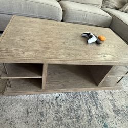 Modern wood coffee table with lower storage shelves 