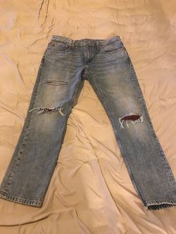 Levi’s blue jeans with custom red and black printed rips