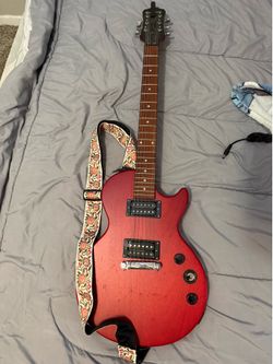 Electric guitar with capo