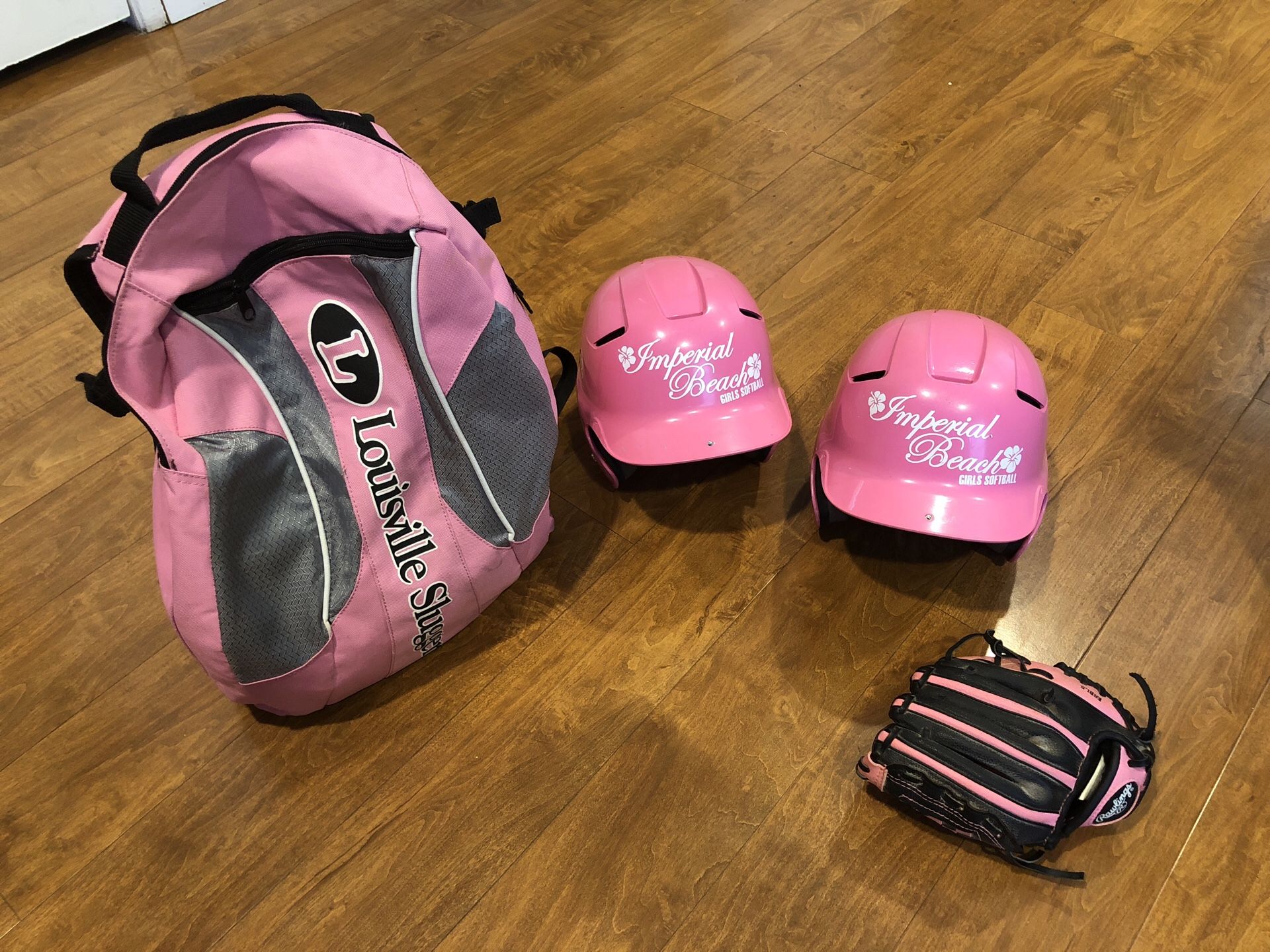 Softball bag and helmets and a lefty glove