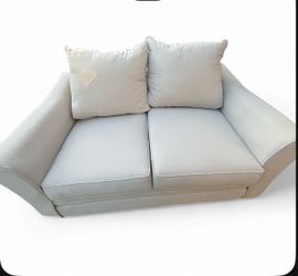 Two seat Cream couch with two pillows