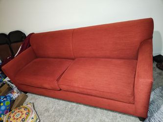 Red couch with couch cover