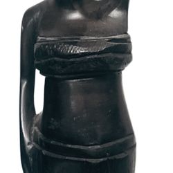 African wood carving of a woman carrying a vessel