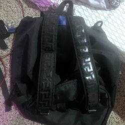 Versace Parfums Medusa Head black nylon drawstring flap backpack. 