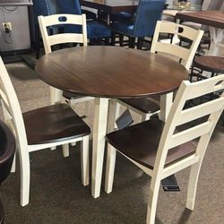OM• $38 Initial • Brand New Woodanwille Dining Set , Table And Chairs