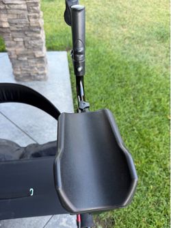 Upright walker with seat and storage pouch