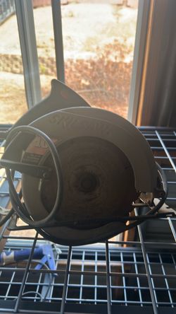vintage SKILSAW Model 77 Super Duty, 7-1/4” worm-drive circular saw.