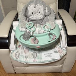 Portable floor seat with snack tray and toys.