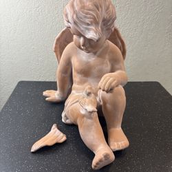 Baby Angel sculpture, empty inside, 8.9lbs, H14”, W8~9”.Deep8~9”. Has 1 glued crack on 1 leg, 1 wing is broken needs fix.