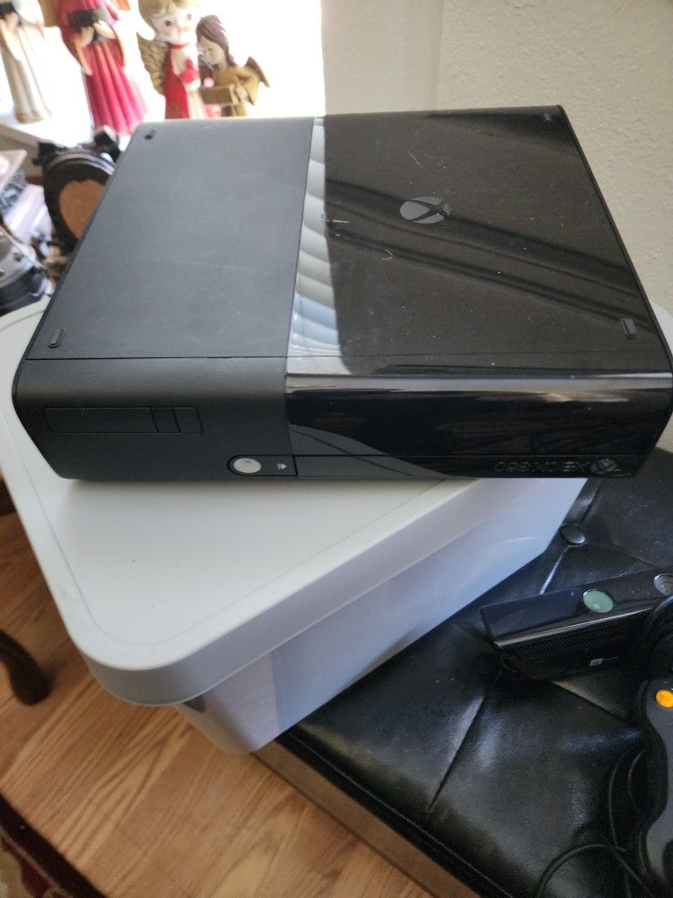 Xbox 360 E has 2 controllers ,kinect ,cables and games works great