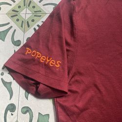 POPEYES Louisiana Kitchen Unisex Work Uniform Embroidered Logo Shirt Adult Medium Brick Red   Great pre-owned condition.   Pick up available in Arling