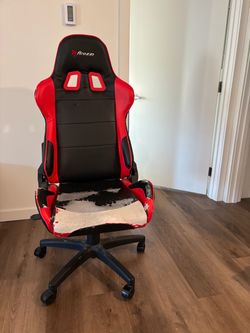 Worn, armless gaming chair