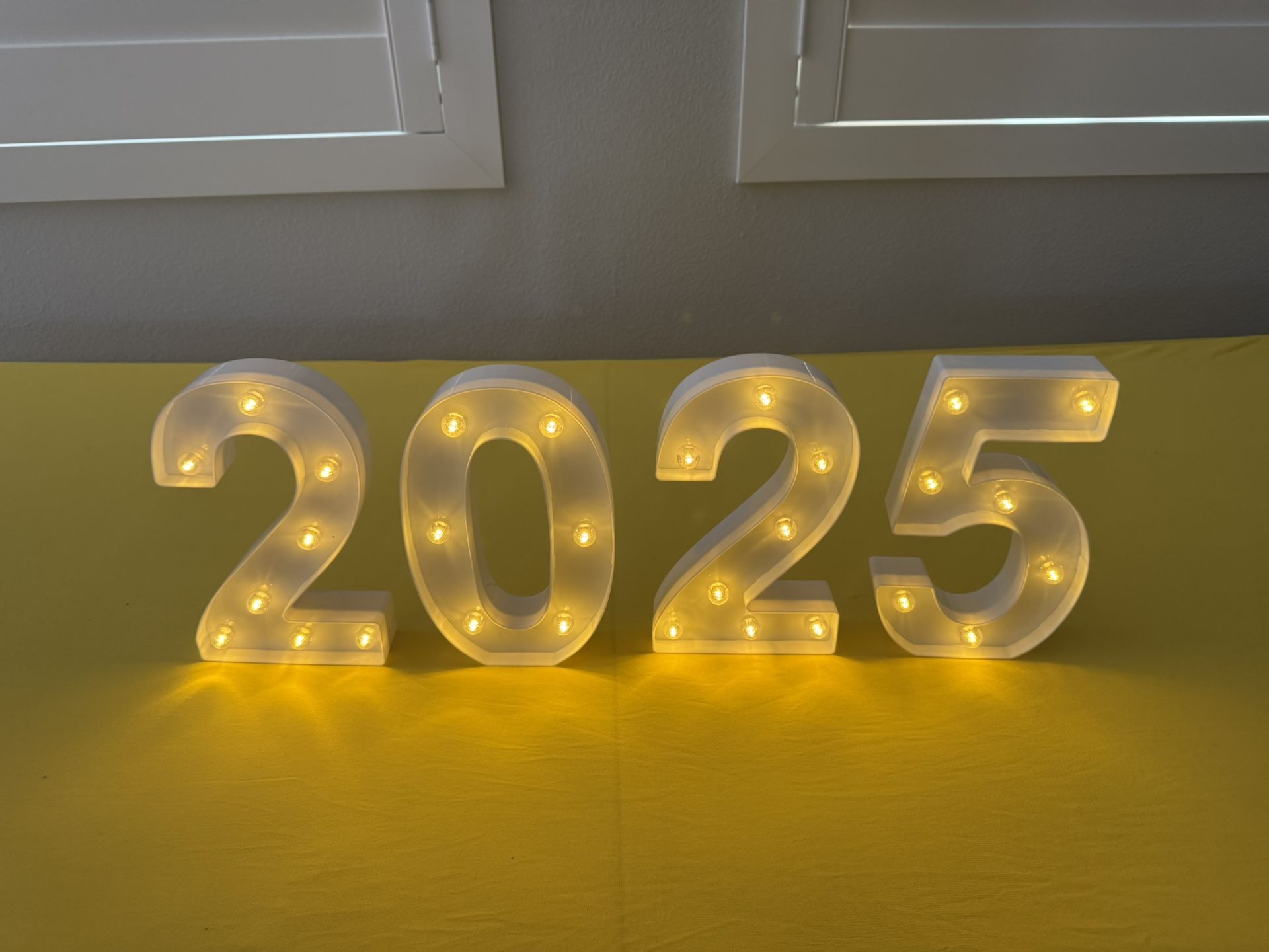 2025 Lit Display and Yellow Table Cloth