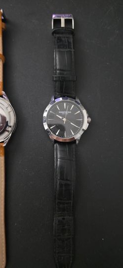 Kenneth Cole New York men's wrist watch with a black dial, silver-tone case, and a textured black leather strap