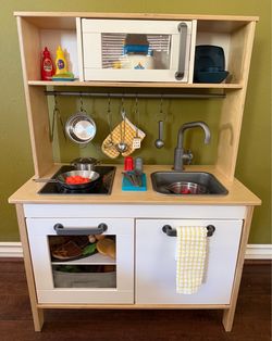 IKEA Dutkig Birch Wood Toy Kitchen. Excellent Condition.  Included all accessories shown.   Tea Pot Whistles and Perks.  Cook Top Lights Up.