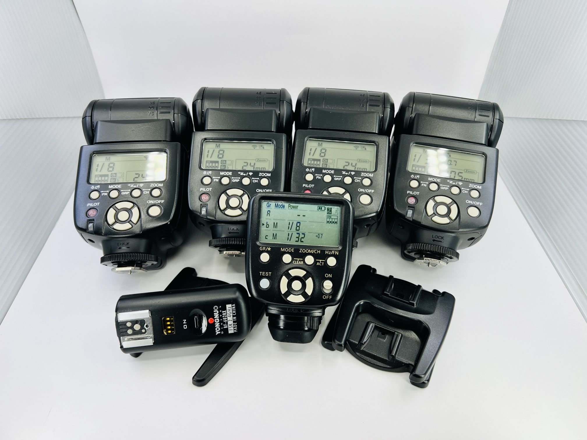 four Yongnuo YN560 III manual speedlites, a Yongnuo YN560-TX II manual flash controller, and a Yongnuo RF-602RX wireless receiver