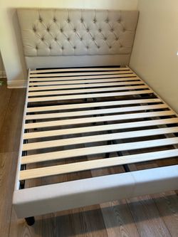 Queen size upholstered bed frame like new 1 year old in guest room