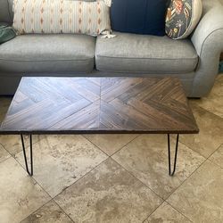 Wood coffee table with black metal legs