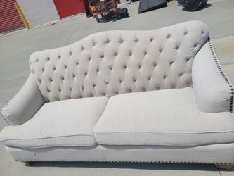 Like new Luciano tufted linen sofa with beautiful nail head detail.