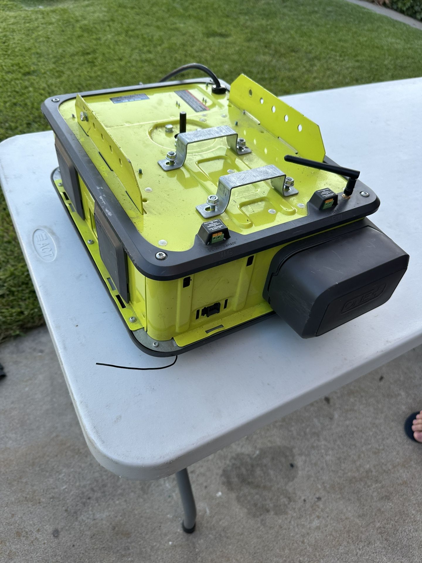 The image shows a Ryobi Ultra-Quiet 2 HP Belt Drive Garage Door Opener.