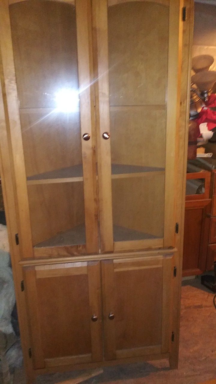 Small wooden corner shelf with glass doors