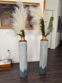 Pair of tall vases with greenery
