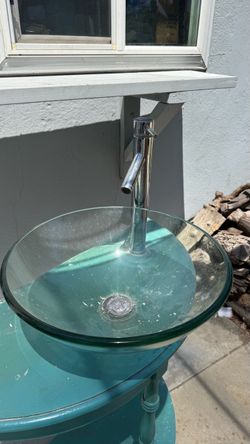 Glass wash basin with faucet