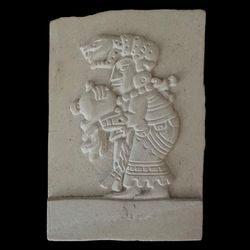 Vintage Decorative stone relief Mesoamerican carving inspired by ancient Mayan art featuring a figure, commonly associated with Mayan deities