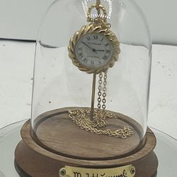 New M.I. Hummel Figurine Pocket Watch With Gold Chain Goebel & Display Cloche   This beautiful M.I. Hummel figurine pocket watch with gold chain is a 