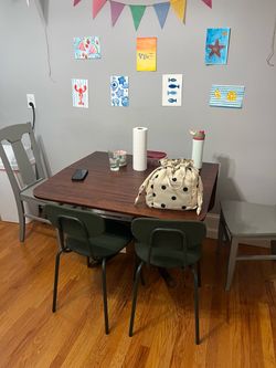 Dark Wood Drop-Leaf Dining Table with Two Green Chairs