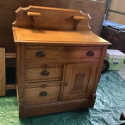 Antique oak wooden wash sink 1920s on wheels all drawers work Candle holder shelves approximately 30” wide Approximately 28” tall 3 drawers and one ca