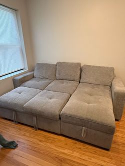 Gray sectional couch with storage and charging station