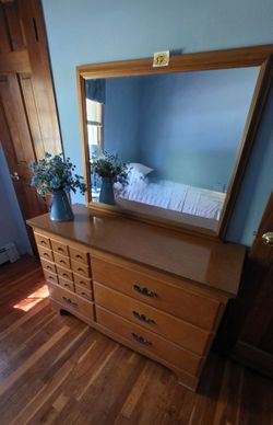 Solid bedroom dresser with mirror.