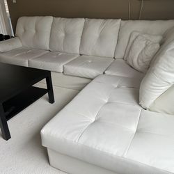 White sectional couch and table