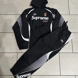 Supreme®/Umbro Track Jacket, a collaboration featuring water-resistant nylon, a football-inspired design, and prominent branding