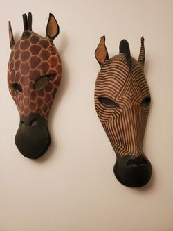 Hand carved and painted zebra and giraffe heads