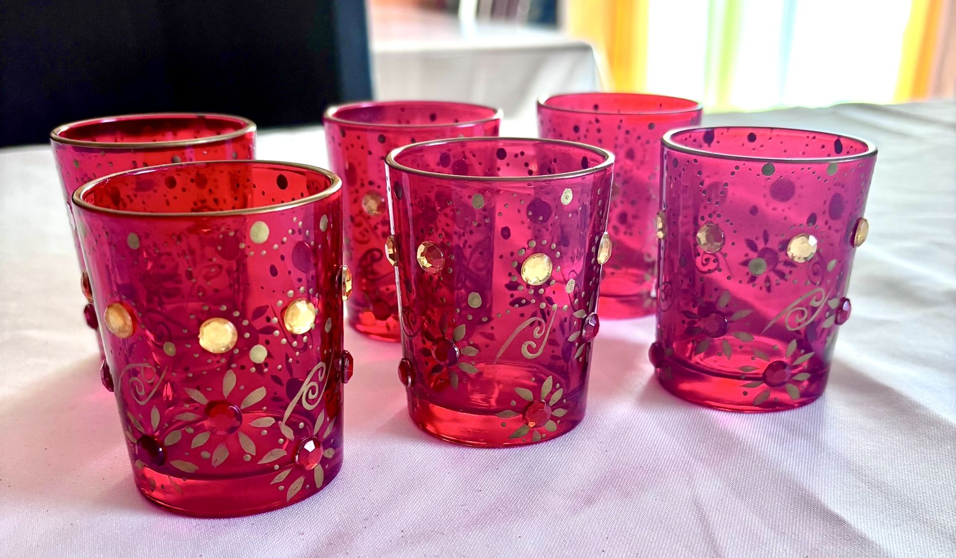 PIER 1 SET OF RED BEJEWELED CANDLE HOLDERS.